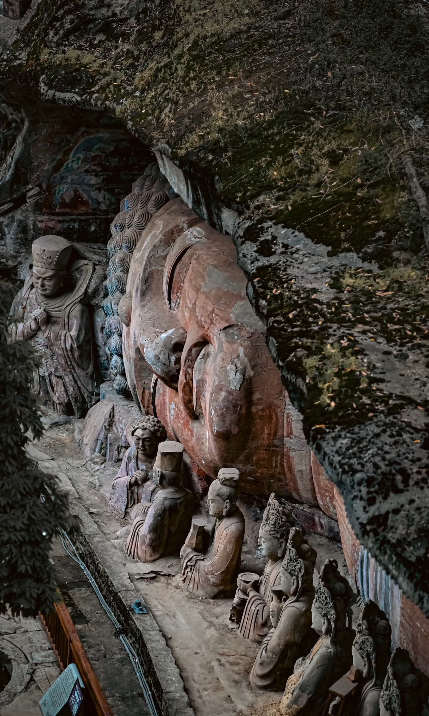 Intricate and ancient Buddhist carvings on a rock face at Dazu