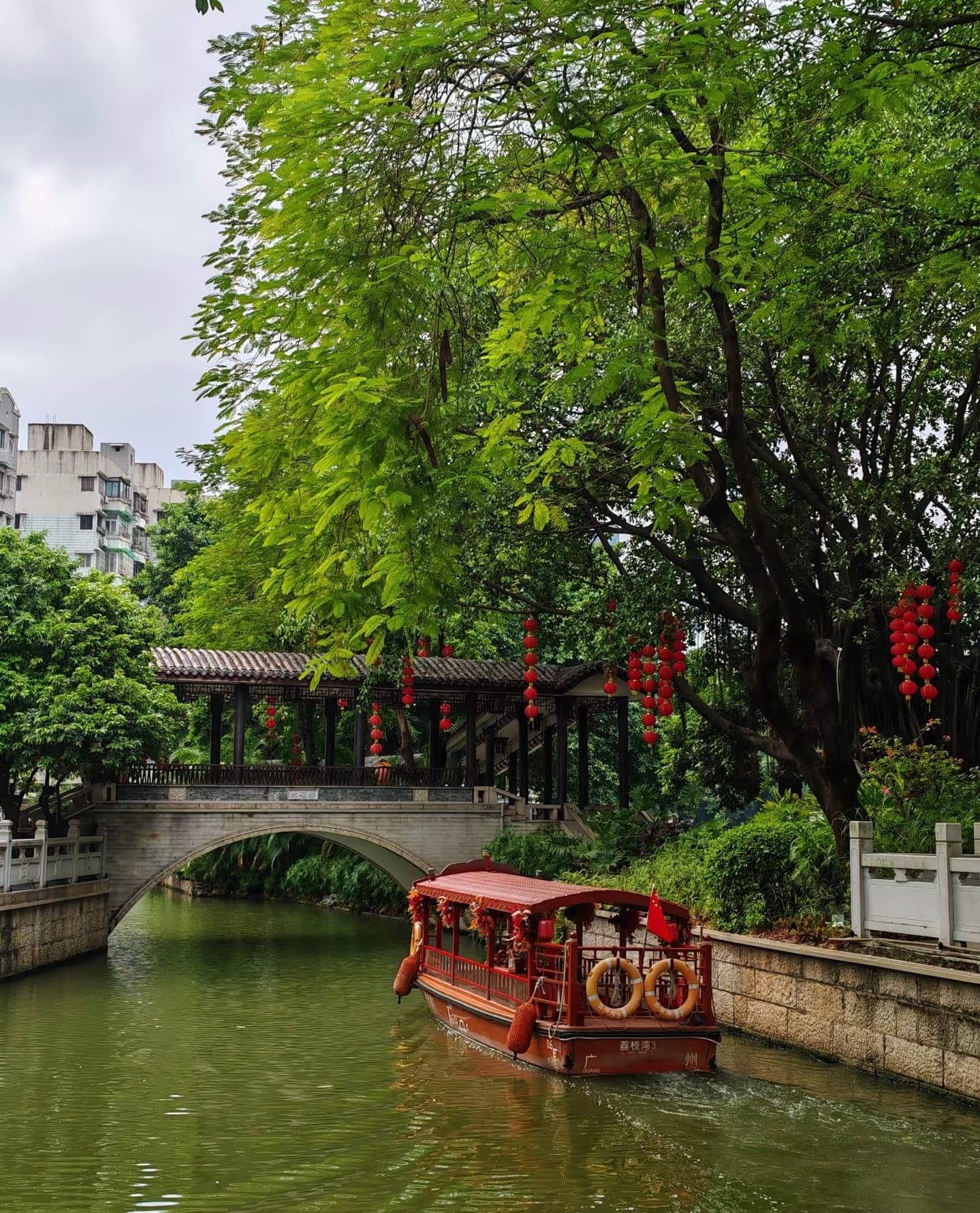 Charming canal scene at Lychee Bay with traditional boats and bridges