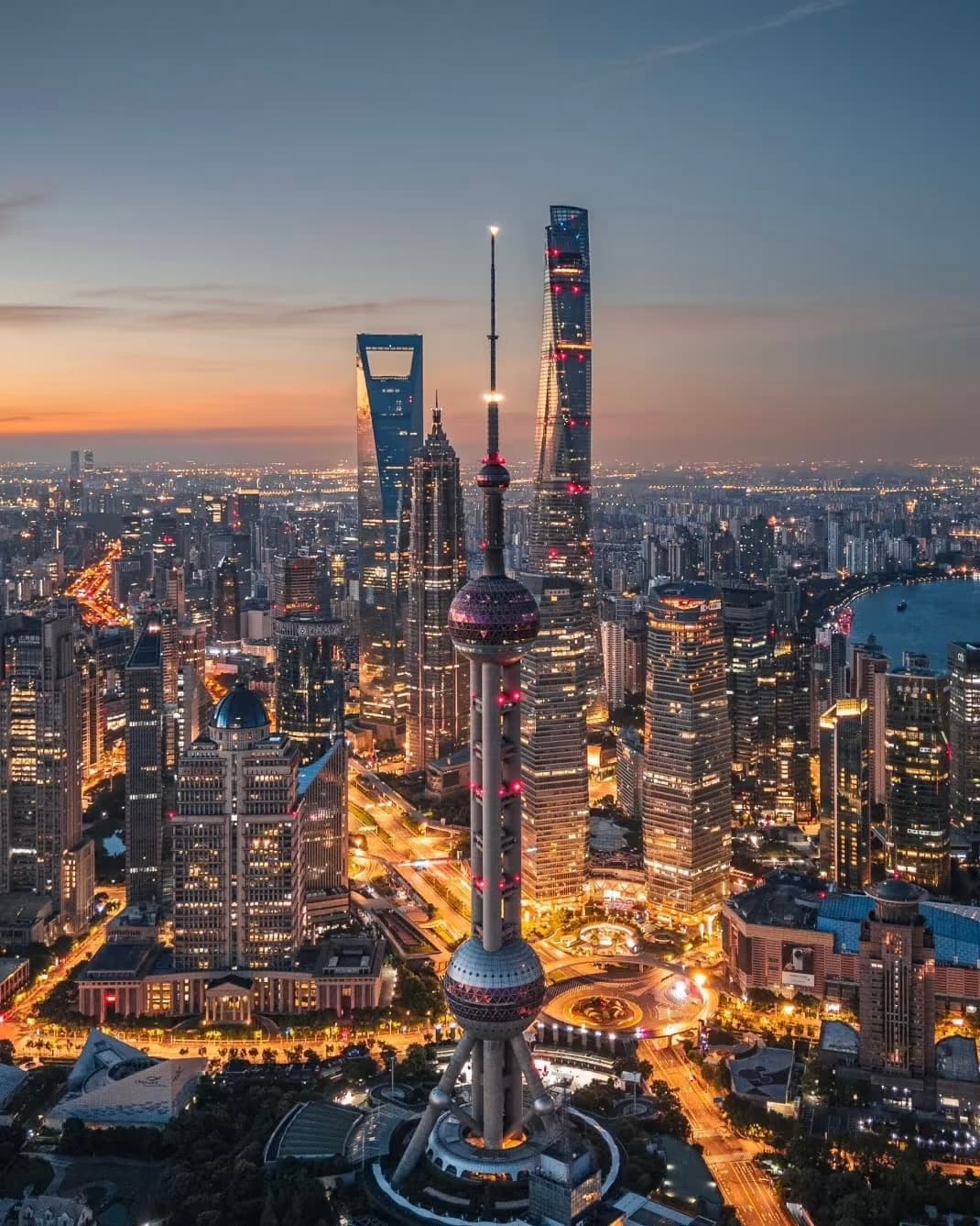 Night view of Shanghai's Bund with illuminated colonial buildings and the modern skyline across the river